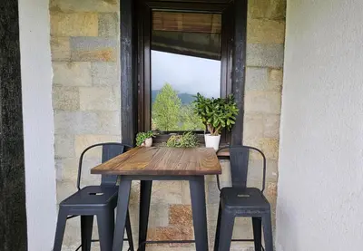 a wooden table with two chairs and a window at Pravets Lake Home away from home in Pravets