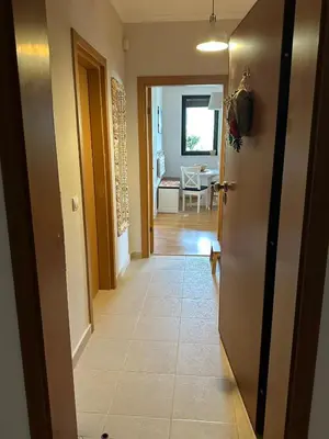 a hallway with a door leading to a dining room at Pravets Lake Home away from home in Pravets