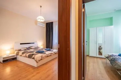 a bedroom with a bed and a sliding glass door at 2 bedroom Urban retreat in Sofia