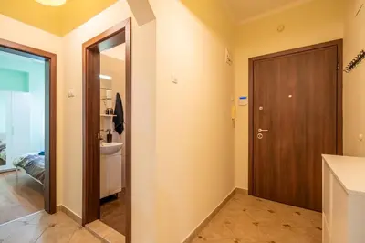 a bathroom with a wooden door and a sink at 2 bedroom Urban retreat in Sofia