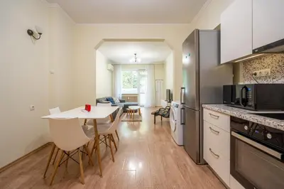a kitchen with a white table and chairs in a room at 2 bedroom Urban retreat in Sofia