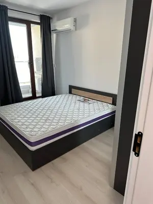 a bed in a room with a window at Lovely Stylish Brand New Flat in Sofia