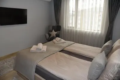 a bedroom with a bed with towels on it at Апартамент Гончеви in Velingrad