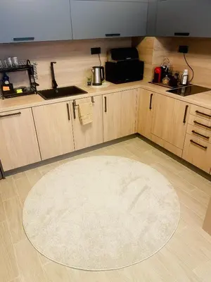 a kitchen with a large rug on the floor at Апартамент Гончеви in Velingrad