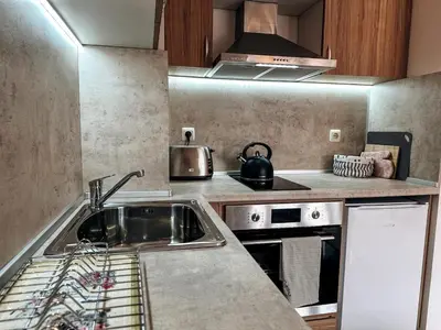 a kitchen with a sink and a stove at Pirin Apartament in Bansko