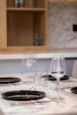 three wine glasses sitting on a kitchen counter at Brand new Apartments in Sofia Center, Steps to Metro, NDK, Vitosha boulevard in Sofia
