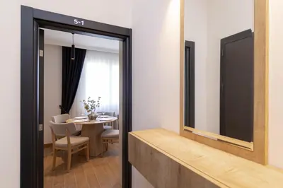 a dining room with a table and a mirror at Brand new Apartments in Sofia Center, Steps to Metro, NDK, Vitosha boulevard in Sofia