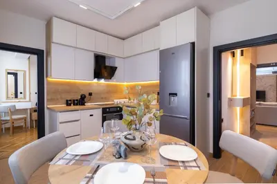 a kitchen and dining room with a table and chairs at Brand new Apartments in Sofia Center, Steps to Metro, NDK, Vitosha boulevard in Sofia