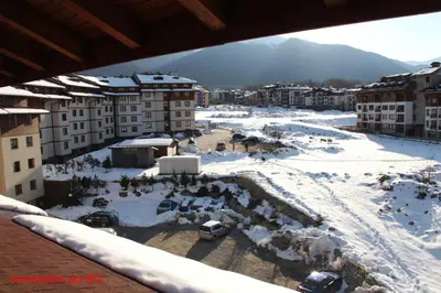 an aerial view of a snow covered city with buildings at Banskodom in Bansko