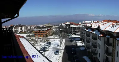 a city with snow covered roofs and buildings at Banskodom in Bansko