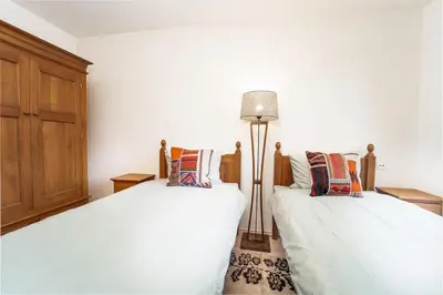 two beds sitting next to each other in a room at Host2U Mountain 2 Bedrooms - Fireplace in Bansko