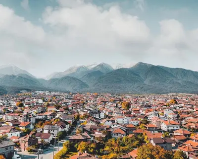an aerial view of a city with mountains in the background at Host2U Mountain 2 Bedrooms - Fireplace in Bansko