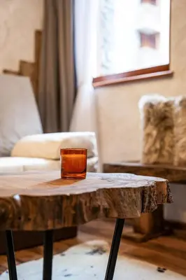 a wooden coffee table with a glass on top of it at Host2U Authentic Bansko Apartment - Free Parking in Bansko