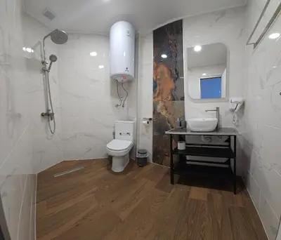 a bathroom with a toilet and a sink and a mirror at Къща за гости ЕСТЕТ ESTET Guest house in Oreshak