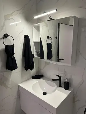 a white bathroom with a sink and a mirror at Cherry in Sofia
