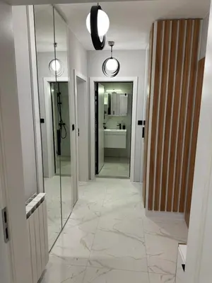 a hallway of a bathroom with a mirror and a sink at Cherry in Sofia