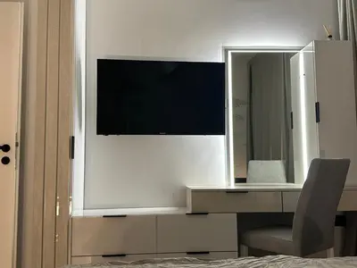 a bedroom with a desk with a mirror and a chair at Cherry in Sofia