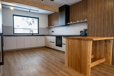 a kitchen with wooden cabinets and a counter top at Chalet Pamporovo in Pamporovo