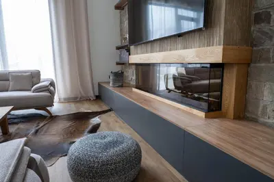 a living room with a fireplace and a tv at Chalet Pamporovo in Pamporovo
