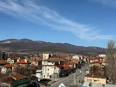 a view of a city with buildings and mountains at PanOrama Luxury Apartments in Panagyurishte