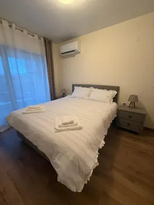 a bedroom with a bed with two towels on it at PanOrama Luxury Apartments in Panagyurishte