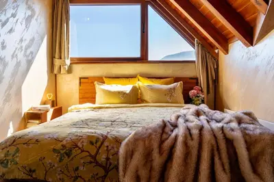 a bedroom with a large bed with a large window at Host2U Penthouse 2-Bedrooms The Best View - Free Parking in Bansko