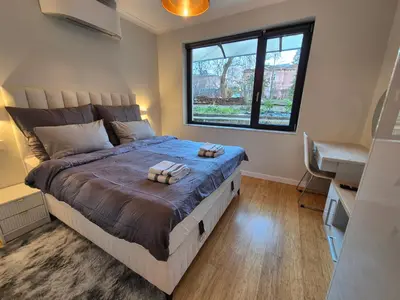 a bedroom with a large bed and a window at The VERTEX in Sofia