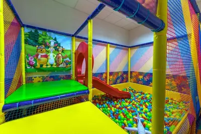 a kids play room with a slide and balls at Golden Lake 526 at Oak Residence in Smolyan