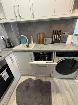 a kitchen with a sink and a washing machine at Snowflake- Luxury stay with a Bottle of Wine,free Parking and SPA in Royal Park in Bansko