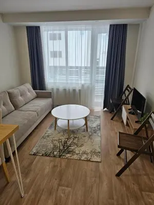 a living room with a couch and a coffee table at Forest Chamkoria Apartment in Borovets
