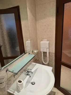 a bathroom with a sink and a mirror at Emerald Apartment - complex Bansko in Bansko