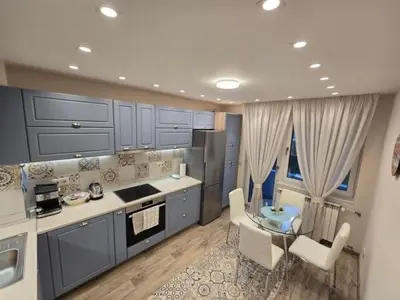 a kitchen with a table and a dining room at Cozy Apartment in the Heart of Sofia, BG in Sofia