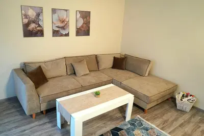 a living room with a couch and a coffee table at Cozy Apartment in the Heart of Sofia, BG in Sofia