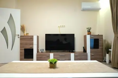 a living room with a flat screen tv on a entertainment center at Cozy Apartment in the Heart of Sofia, BG in Sofia
