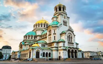 a large building with a dome on top of it at Cozy Apartment in the Heart of Sofia, BG in Sofia