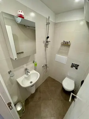 a bathroom with a sink and a toilet at Pirin Cozy Escape 8 min walk from ski lift - Private Apartment Grand Bansko 1 in Bansko