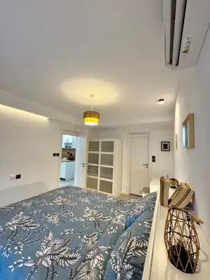 a bedroom with a large bed with a blue comforter at Pirin Cozy Escape 8 min walk from ski lift - Private Apartment Grand Bansko 1 in Bansko
