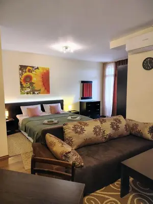 a living room with a bed and a couch at Great view studio Pirin Palace in Bansko