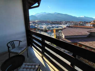 a balcony with a chair and a view of a harbor at Great view studio Pirin Palace in Bansko