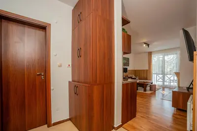 a large wooden cabinet in a room with a kitchen at ЕлеаНора, Смолянски езера EleaNora Smolyan lakes in Smolyan