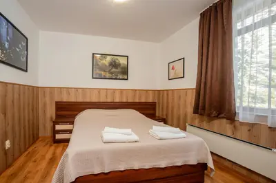 a bedroom with a bed with two towels on it at ЕлеаНора, Смолянски езера EleaNora Smolyan lakes in Smolyan