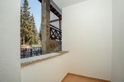 a room with a window with a view of a balcony at ЕлеаНора, Смолянски езера EleaNora Smolyan lakes in Smolyan