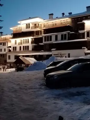 a row of parked cars in front of buildings at Grand Studio B27 in Pamporovo
