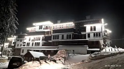 a large building with snow in front of it at night at Grand Studio B27 in Pamporovo