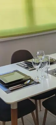 a white table with two wine glasses on it at Spacious, Comfortable Top Central Apartment in Sofia