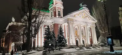 a large building with christmas trees in front of it at Spacious, Comfortable Top Central Apartment in Sofia