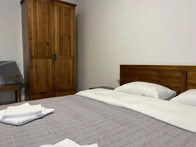 a bedroom with two beds with white towels on the bed at Daliya's Apartment in Bansko