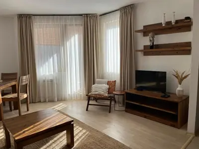 a living room with a television and a table at Daliya's Apartment in Bansko