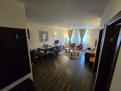a living room with a table and a dining room at Bansko Apartment Next To The Ski Lift in Bansko