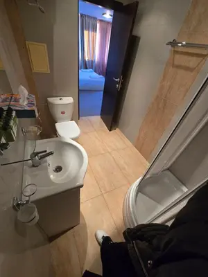 a bathroom with a white sink and a toilet at Bansko Apartment Next To The Ski Lift in Bansko